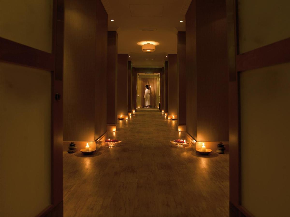 a hallway with candles and a person in the distance at Macdonald Bath Spa Hotel in Bath